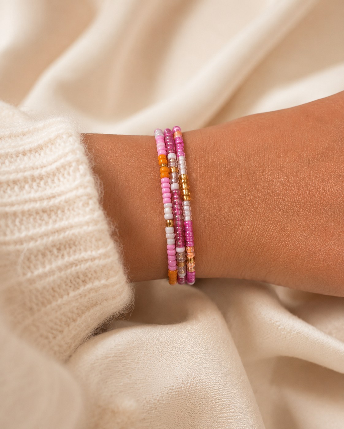 Hibiscus bracelet stack worn on the wrist.