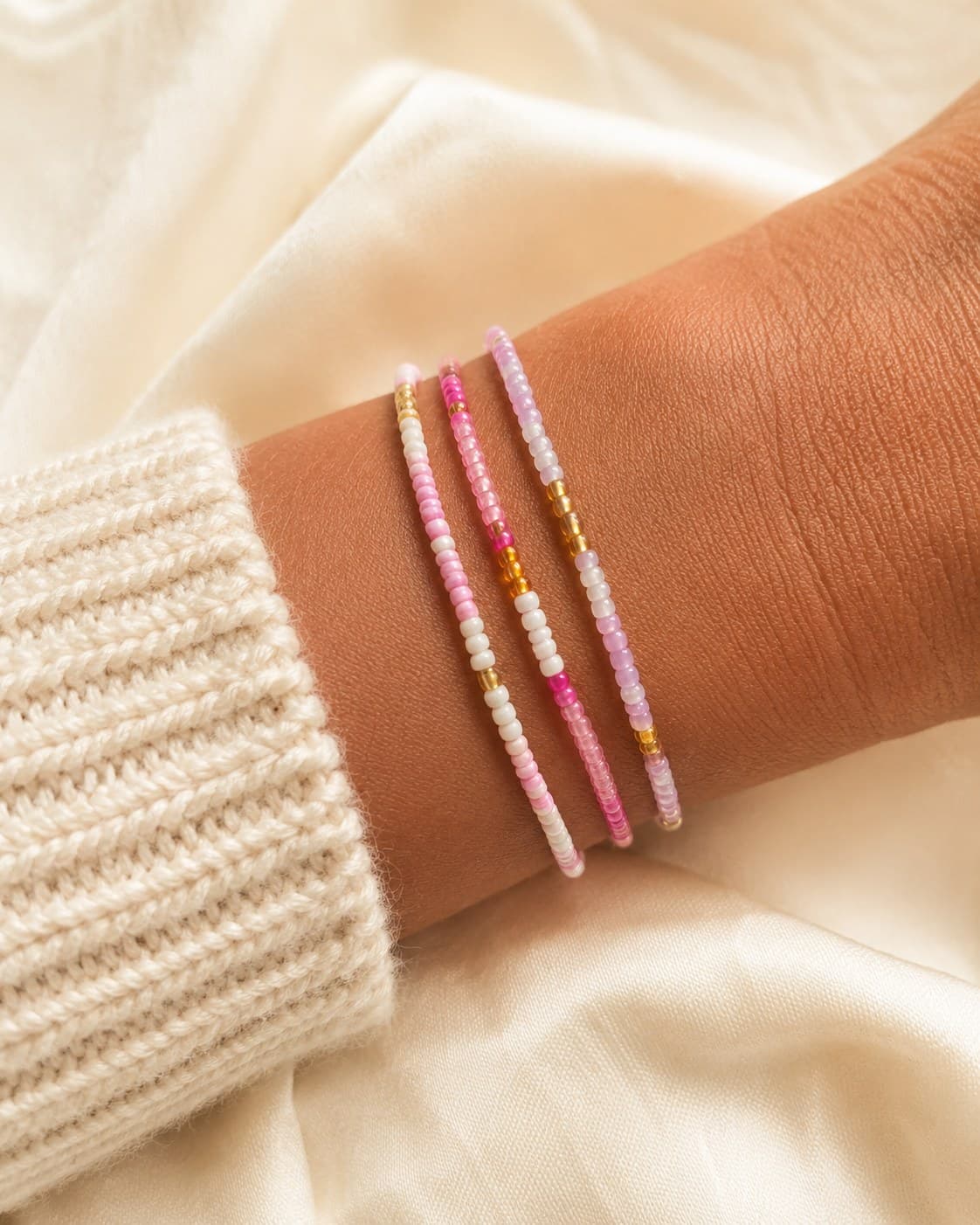 Raspberry Fizz bracelet stack worn on the wrist.